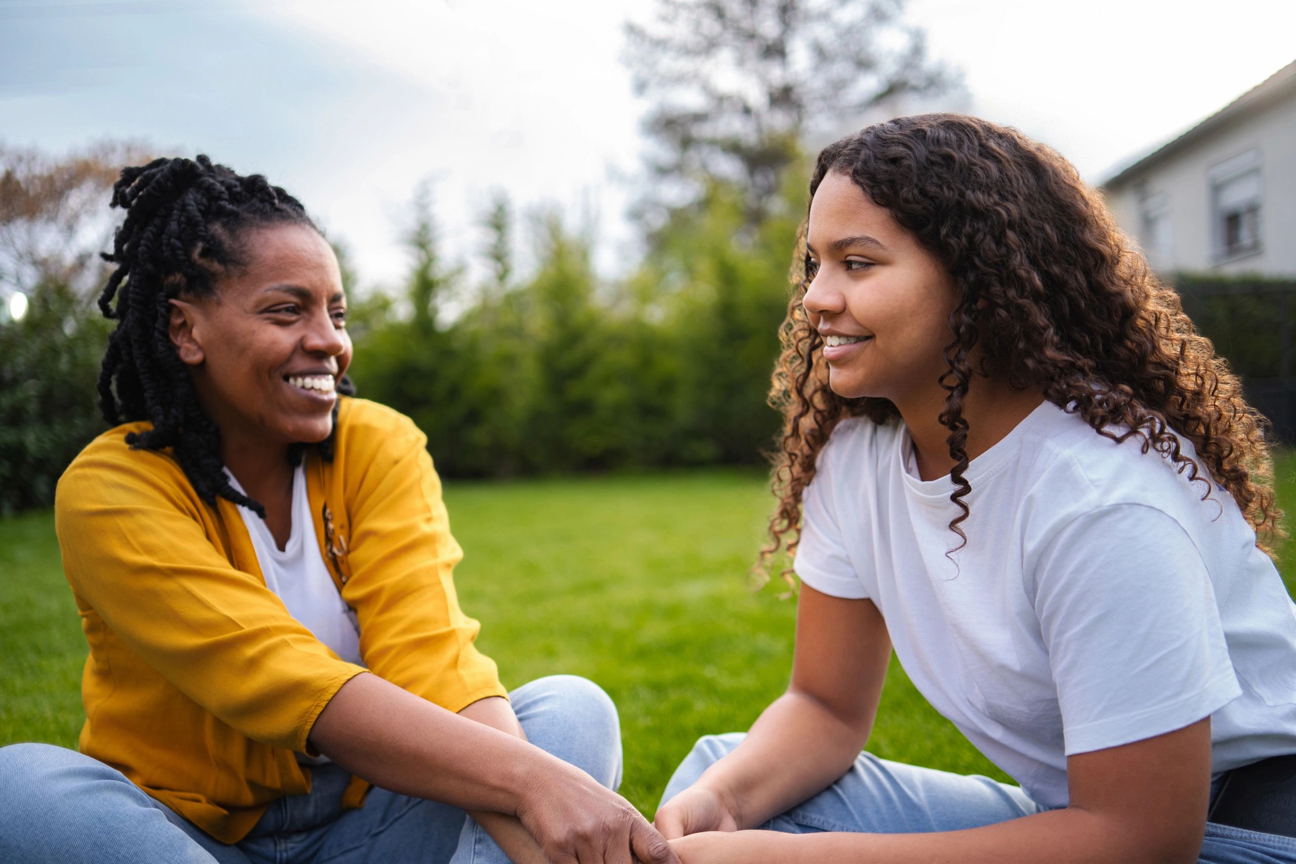 Mother and daughter sharing a hopeful bonding moment outdoors
